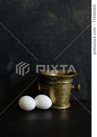 Antique brass Mortar and two white eggs Antique brass Mortar and two white eggs 75688860