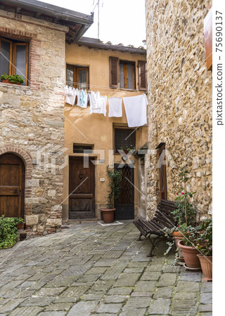 View of medieval street with drying clothes in Castellina di Chianti, Tuscany, Italy 75690137