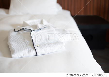 Pajamas and nightwear on the hotel bed Pajamas and nightwear on the hotel bed 75690880