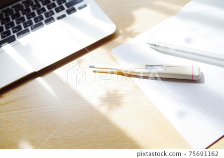 Thermometer, computer, mask and writing utensils at home Thermometer, computer, mask and writing utensils at home 75691162