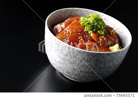 Two-color pickled rice bowl of tuna and salmon shot on a black background Two-color pickled rice bowl of tuna and salmon shot on a black background 75693571