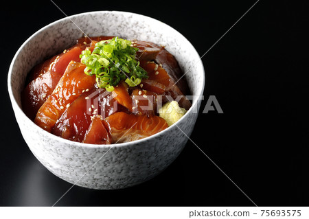 Two-color pickled rice bowl of tuna and salmon shot on a black background 75693575