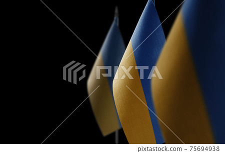 Small national flags of the Ukraine on a black background 75694938