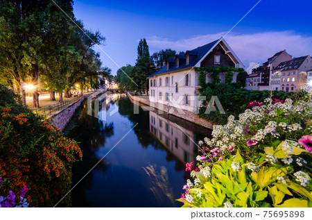 Strasbourg, France, August 2019. The historic center offers the view of pleasant and relaxing glimpse: the characteristic period houses are reflected on the water mirror of the canals. Blue hour Strasbourg, France, August 2019. The historic center offers the view of pleasant and relaxing glimpse: the characteristic period houses are reflected on the water mirror of the canals. Blue hour 75695898