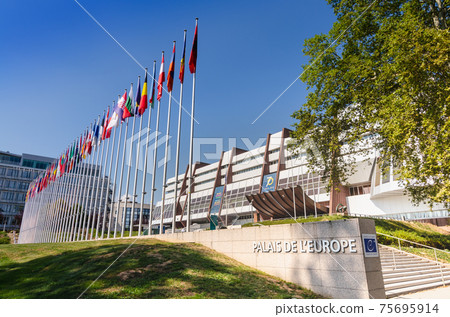Strasbourg, France, August 2019. Three-quarter view of the Palace of Europe, the building that houses the headquarters of the Council of Europe. In evidence the banidiere of the member states. Strasbourg, France, August 2019. Three-quarter view of the Palace of Europe, the building that houses the headquarters of the Council of Europe. In evidence the banidiere of the member states. 75695914