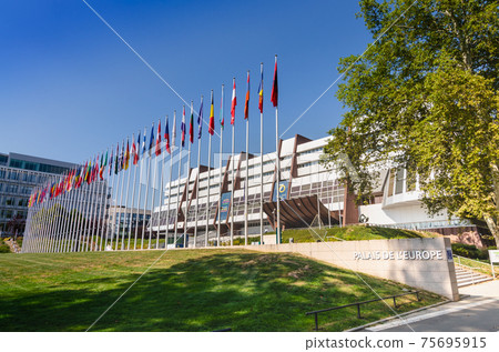 Strasbourg, France, August 2019. Three-quarter view of the Palace of Europe, the building that houses the headquarters of the Council of Europe. In evidence the banidiere of the member states. Strasbourg, France, August 2019. Three-quarter view of the Palace of Europe, the building that houses the headquarters of the Council of Europe. In evidence the banidiere of the member states. 75695915