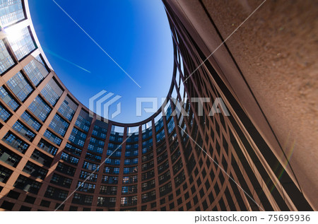 Strasbourg, France, August 2019. View of the inner courtyard of the European parliament. The particular elliptical shape strikes the visitor. Beautiful sunny summer day Strasbourg, France, August 2019. View of the inner courtyard of the European parliament. The particular elliptical shape strikes the visitor. Beautiful sunny summer day 75695936