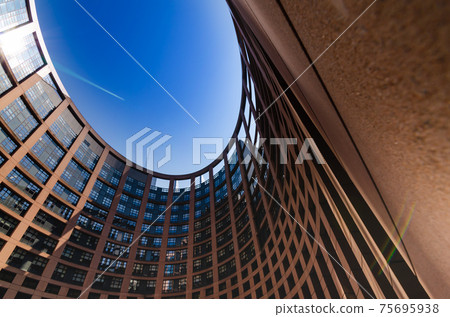 Strasbourg, France, August 2019. View of the inner courtyard of the European parliament. The particular elliptical shape strikes the visitor. Beautiful sunny summer day Strasbourg, France, August 2019. View of the inner courtyard of the European parliament. The particular elliptical shape strikes the visitor. Beautiful sunny summer day 75695938