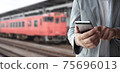 Businessman use smartphone for booking a ticket. 75696013