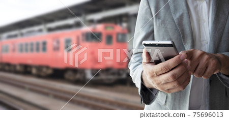 Businessman use smartphone for booking a ticket. Businessman use smartphone for booking a ticket. 75696013