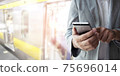 Businessman use smartphone for booking a ticket. 75696014