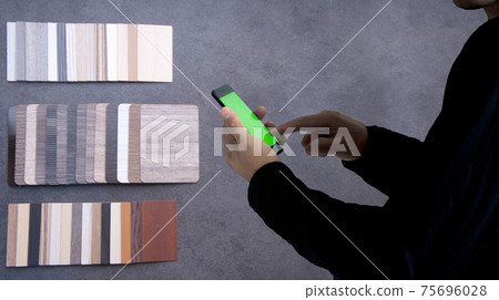 Materials Concept. Young man shopping matrials on mobile Materials Concept. Young man shopping matrials on mobile 75696028
