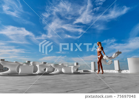 The young woman in white pareo on a terrace and blue sky on a background 75697048