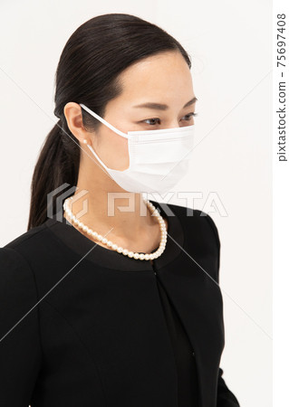 Woman in mourning mask profile 75697408