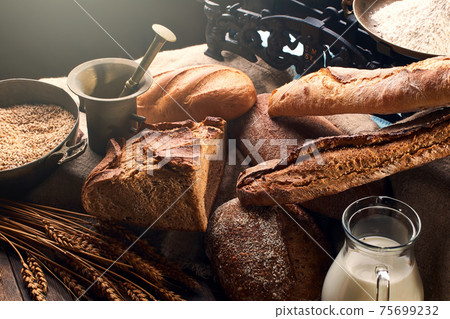 Still life with bread and its ingredients in vintage setting. 75699232