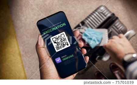 Health Vaccine Passport for Coronavirus or Covid-19. Traveller Using Mobile Phone with Vaccination in Immune Status to Certificated International Traveling  in Airport 75701039
