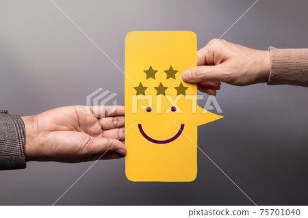Customer Experience Concept. Happy Client giving a Five Star Rating and Smiling Face Feedback on Bubble Speech Card to a Businessman. Positive Review. Satisfaction Survey. High Best Excellent Score Customer Experience Concept. Happy Client giving a Five Star Rating and Smiling Face Feedback on Bubble Speech Card to a Businessman. Positive Review. Satisfaction Survey. High Best Excellent Score 75701040