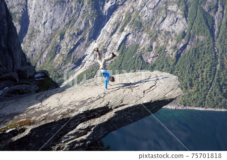 man stands on his hands in Troll language. Norway man stands on his hands in Troll language. Norway 75701818