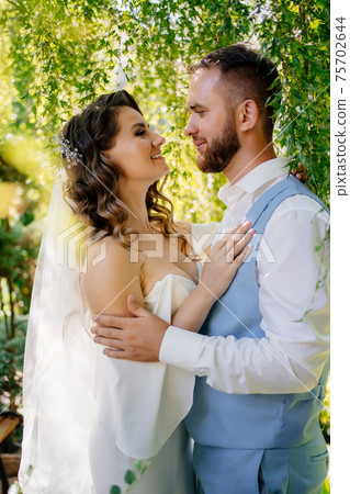 groom in blue suit and bride with curls of stand in willow groom in blue suit and bride with curls of stand in willow 75702644