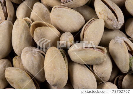 Pile of Pistachio Nuts Closeup View 75702707