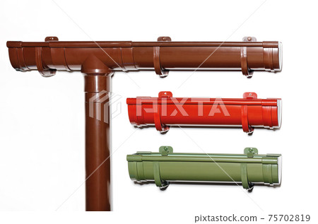 Plastic gutter system on a gray light wall, copy space. Plastic gutter system on a gray light wall, copy space. 75702819