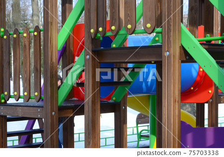 Fragment of a playground made of plastic and wood, painted in different colors Fragment of a playground made of plastic and wood, painted in different colors 75703338