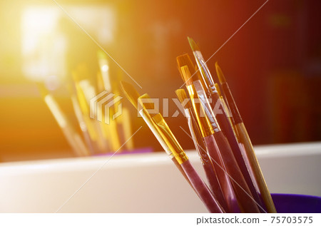 Art paint brushes in cup are located in the children's entertainment hall at the mirror Art paint brushes in cup are located in the children's entertainment hall at the mirror 75703575