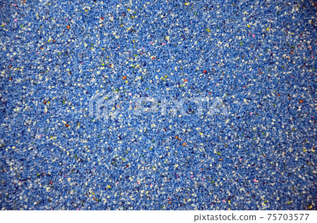 Texture of a colored granular sand close up. Blue grains 75703577