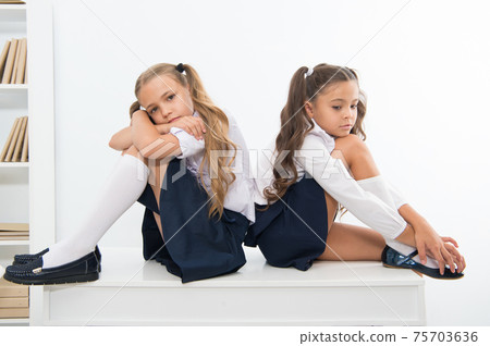 insult. insult of two small girls children or sisters at school. small girls in school uniform. insult. insult of two small girls children or sisters at school. small girls in school uniform. 75703636