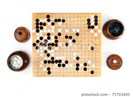 Goban, Baduk, Weiqi or Maklom - Traditional asian strategy board game. black and white stone of Chinese board game Goban, Baduk, Weiqi or Maklom - Traditional asian strategy board game. black and white stone of Chinese board game 75703895