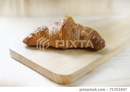 delicious fresh croissants on wood background - French breakfast 75703897