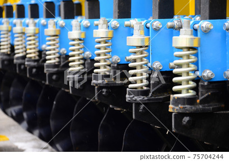 Spring system of agricultural seeder close up 75704244