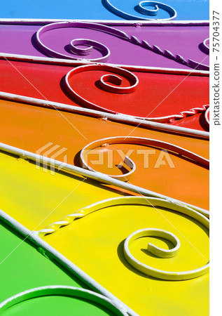 Metal texture of a piece of colored wall with a forged pattern Metal texture of a piece of colored wall with a forged pattern 75704377