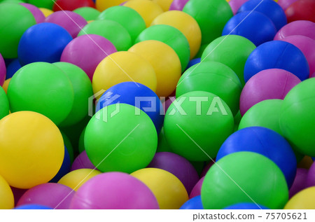 Swimming pool for fun and jumping in colored plastic balls 75705621