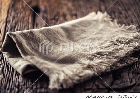 Flax or jute rustical rag folded on dark wooden table 75706179