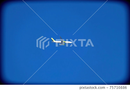 Wide-body plane, with twin turbo engines flies through an impeccable blue sky, 75710886