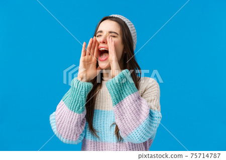 Where are you. Waist-up portrait attractive woman in winter sweater, hat, searching for friend, lost in crowd people on ski resort, calling for help, yelling with hands near opened mouth closed eyes Where are you. Waist-up portrait attractive woman in winter sweater, hat, searching for friend, lost in crowd people on ski resort, calling for help, yelling with hands near opened mouth closed eyes 75714787