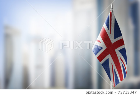 A small flag of United Kingdom on the background of a blurred background A small flag of United Kingdom on the background of a blurred background 75715347
