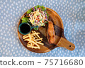 Set of fried salmon steak served on wooden plate 75716680