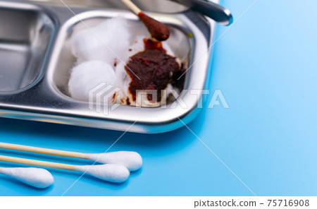 Wound care dressing set and stainless steel plate on blue background. Cotton stick on blur cotton ball with povidone-iodine for wounds, burns and cuts. Wound care supplies. Medical equipment for nurse 75716908