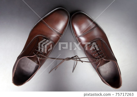 Classic men's brown Oxford shoes on dark background 75717263