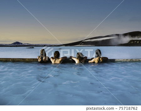 Four women bathing in the Icelandic Blue Lagoon Four women bathing in the Icelandic Blue Lagoon 75718762