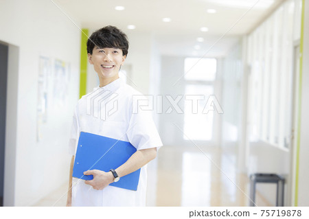 Male business medical caregiver in a white coat Male business medical caregiver in a white coat 75719878