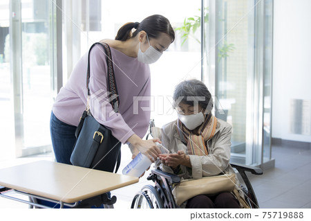 Senior female hand sanitizer parent and child 75719888