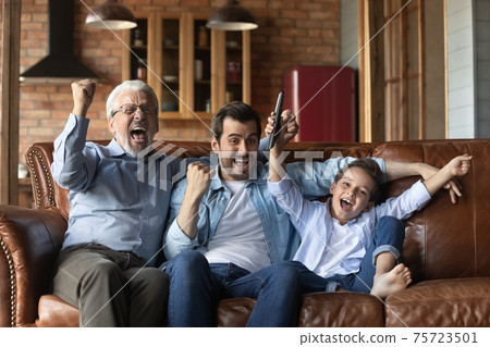 Overjoyed three generations of men celebrate match win 75723501