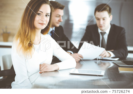 Business woman headshot at workplace in modern office. Unknown businesswoman sitting behind computer monitor. Young accountant or secretary looks good 75726274