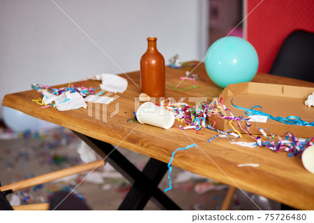 Messy wooden table at morning after party. 75726480