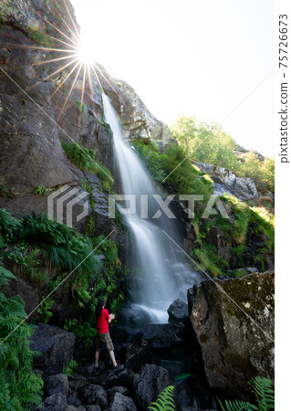 Unrecognizable person under the waterfall, long exposure Unrecognizable person under the waterfall, long exposure 75726673