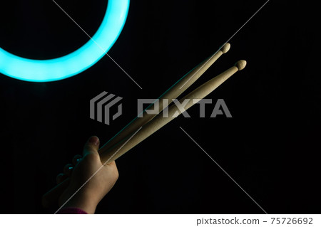 Child Hand Hold Drum Sticks. Rock Music Concept. Child Hand Hold Drum Sticks. Rock Music Concept. 75726692