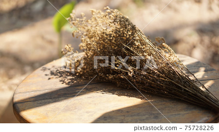 dried flower on wooden table at patio 75728226